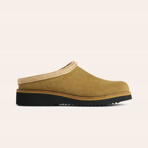 Stylish tan suede clogs with braided trim and durable black outsole for comfort and support.