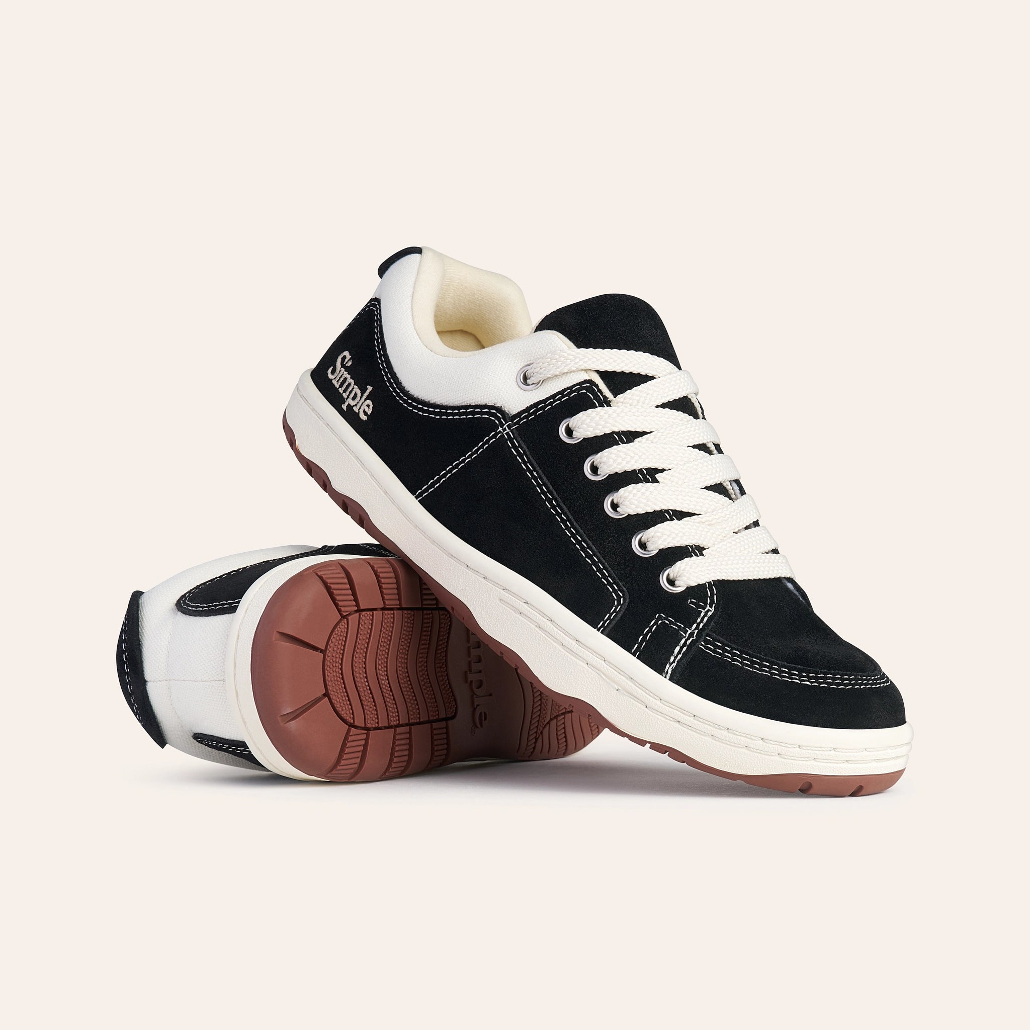 Black suede casual sneakers with white laces and rubber sole by Simple.
