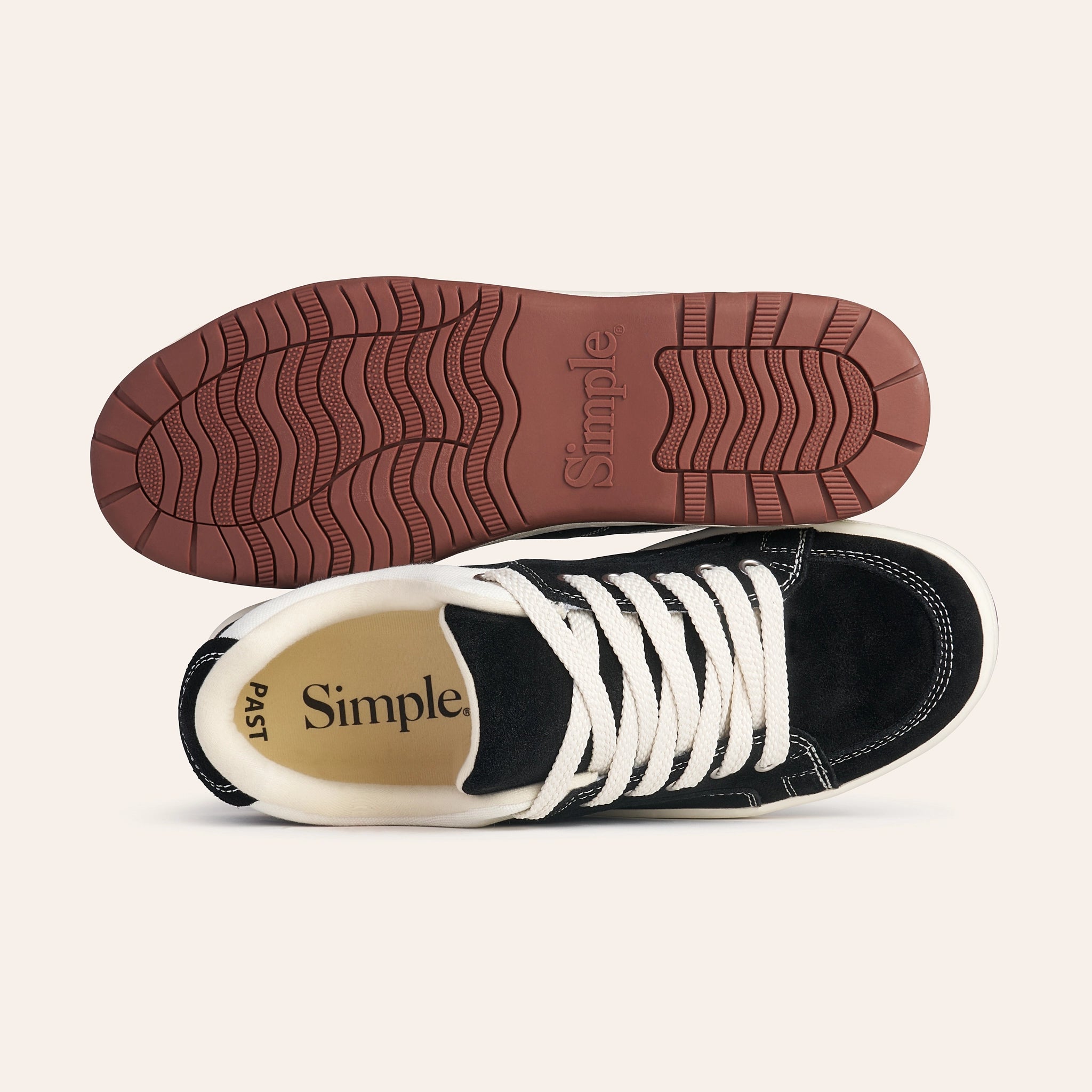 Black suede sneakers with white laces and rubber outsole, featuring a minimalist design.