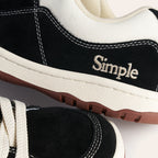 Black suede sneakers with off-white canvas, featuring Simple logo, durable rubber sole.