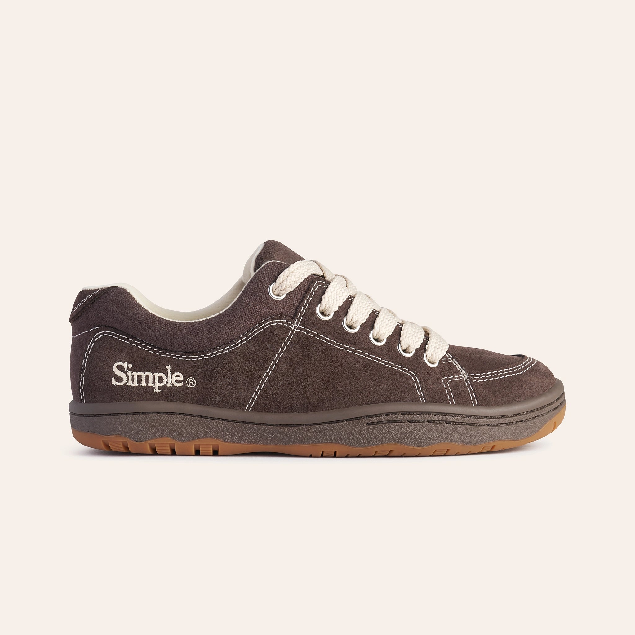 Brown suede sneakers with white laces and rubber sole, featuring Simple logo for casual style.