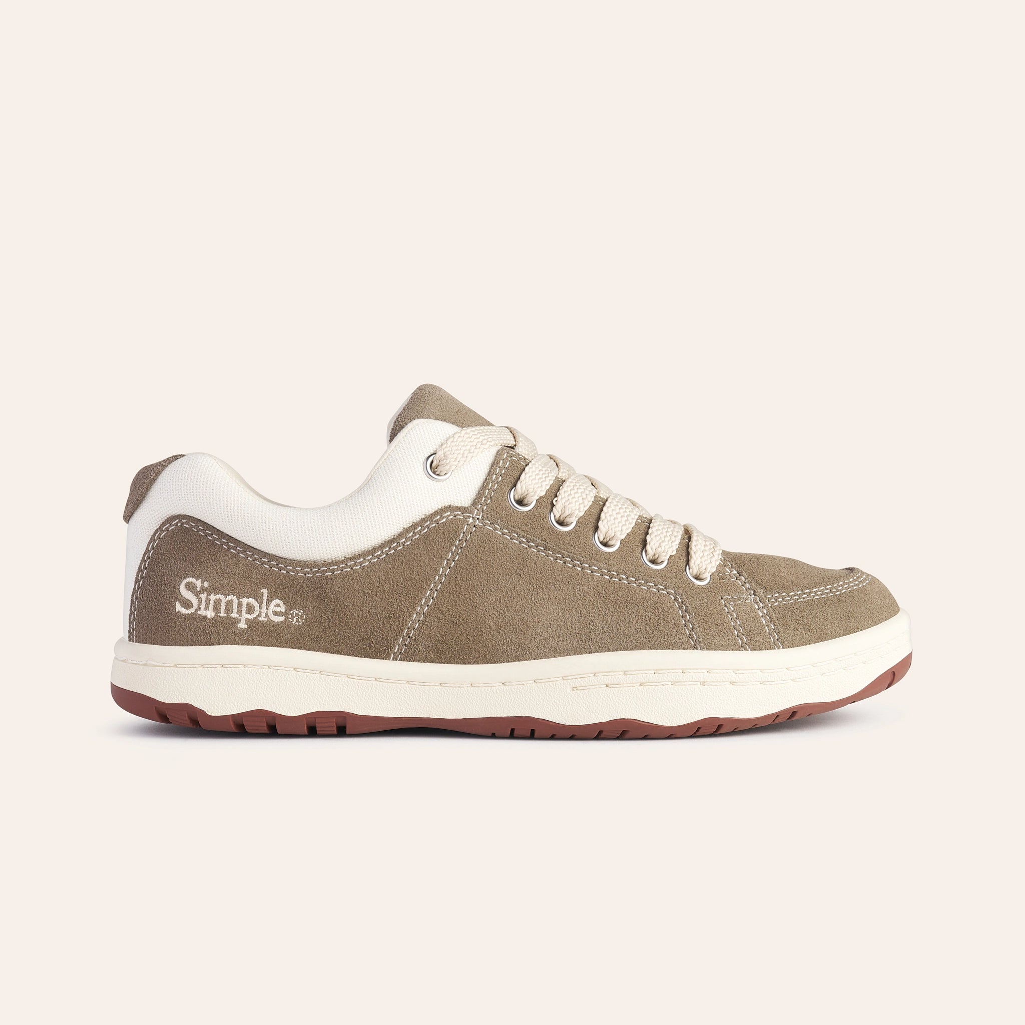 Simple brown suede sneakers with white accents and lace-up design for comfortable casual wear.