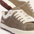 Stylish brown suede sneakers with cream laces and rubber sole, perfect for casual wear.