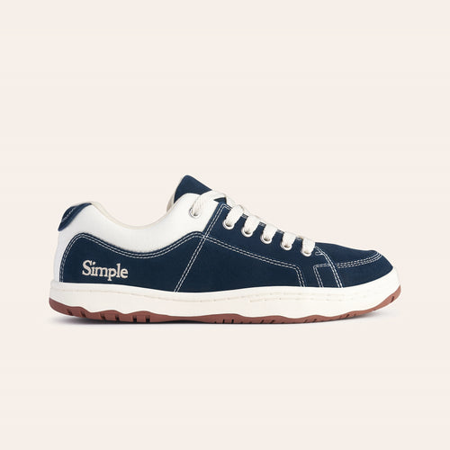 Navy blue canvas sneakers with white accents, featuring lace-up design and durable rubber sole.