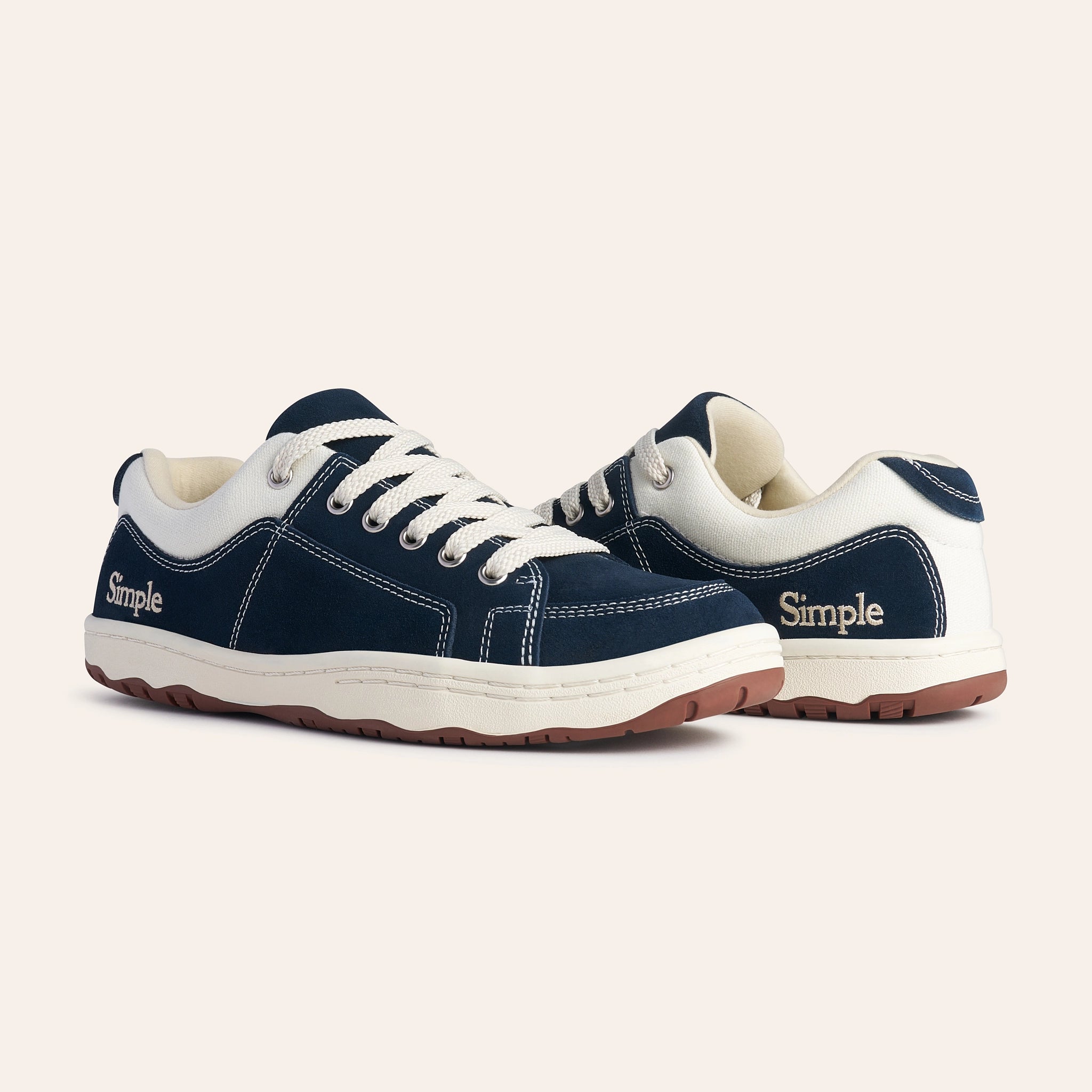 Navy blue casual sneakers with white accents and rubber sole, featuring Simple branding.