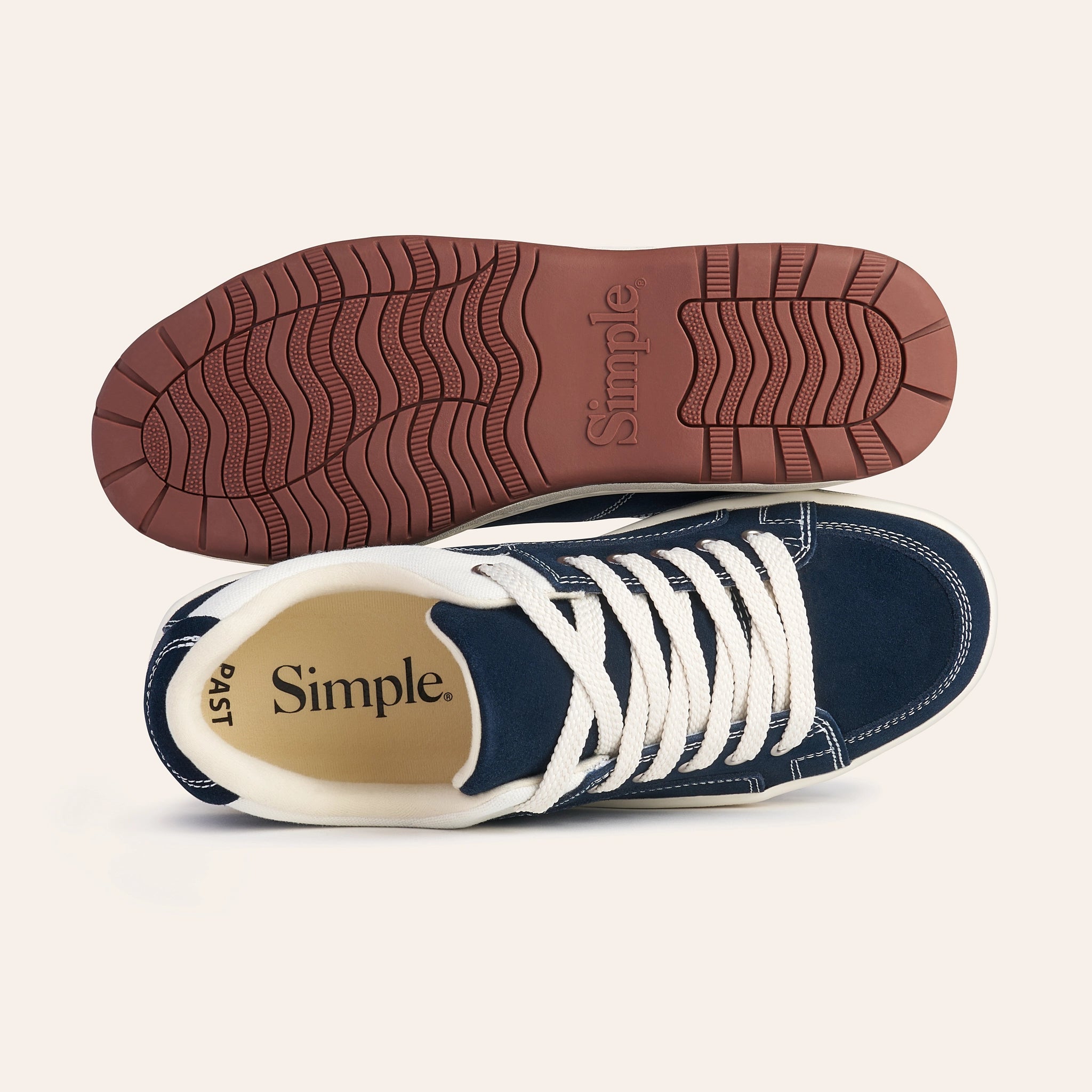 Navy blue casual sneakers with white laces and a brown rubber sole, perfect for everyday wear.