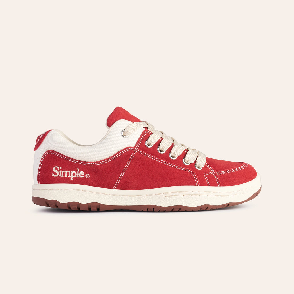 Red suede sneakers with white accents and beige laces, perfect for casual wear.
