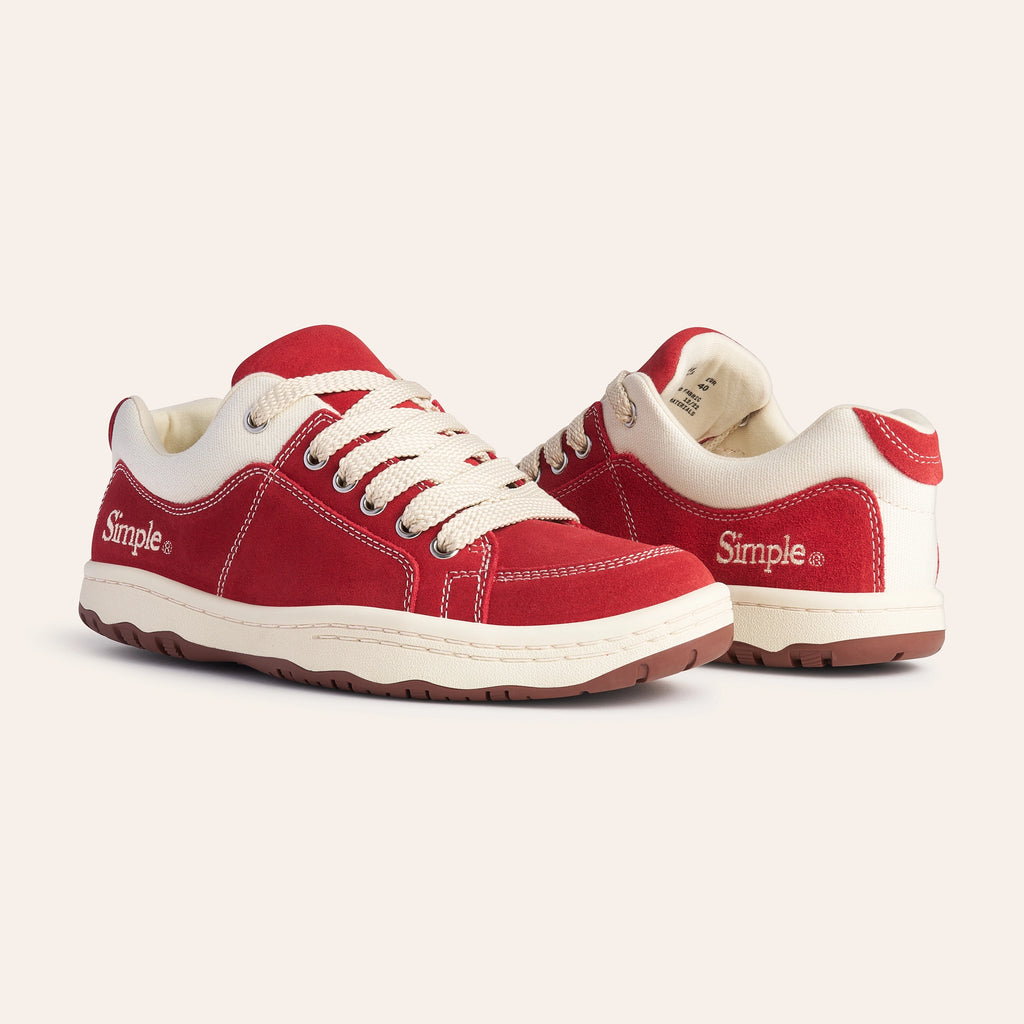 Red suede sneakers with cream laces and details, featuring a comfortable design by Simple.