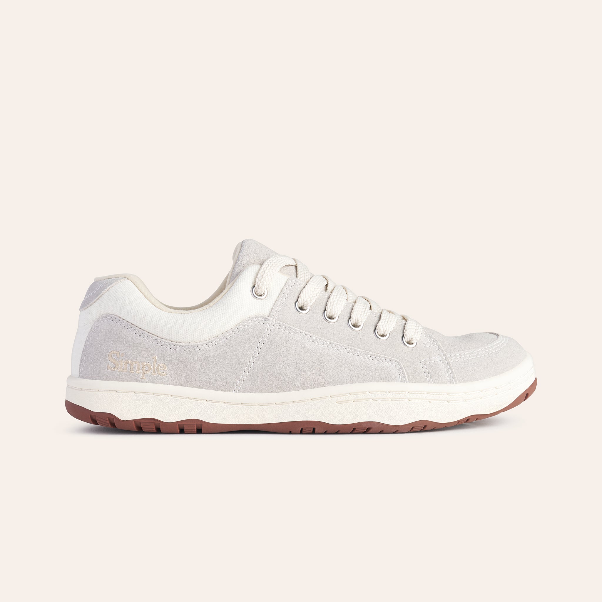 Light grey casual sneakers with suede material and white accents, featuring a comfortable lace-up design.