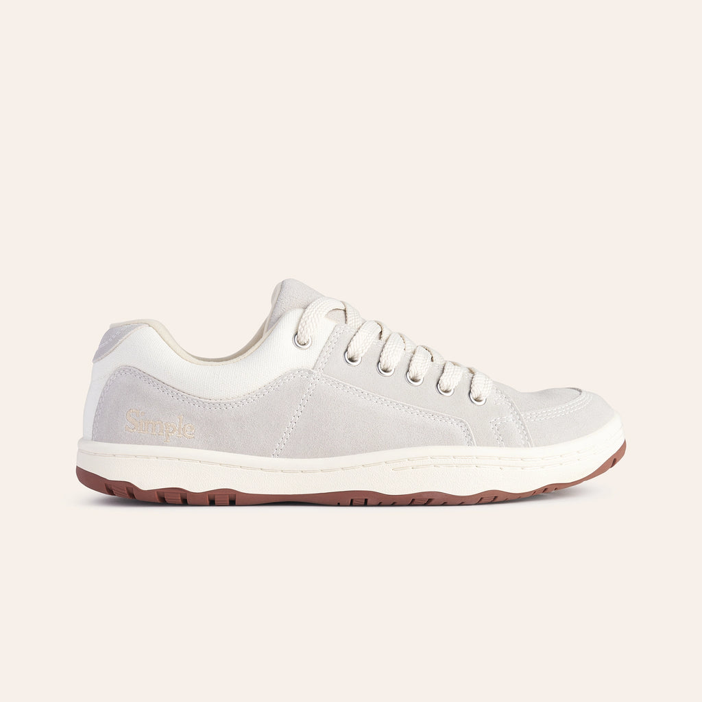 Light gray casual sneakers with suede material and white accents, featuring lace-up closure and rubber outsole.