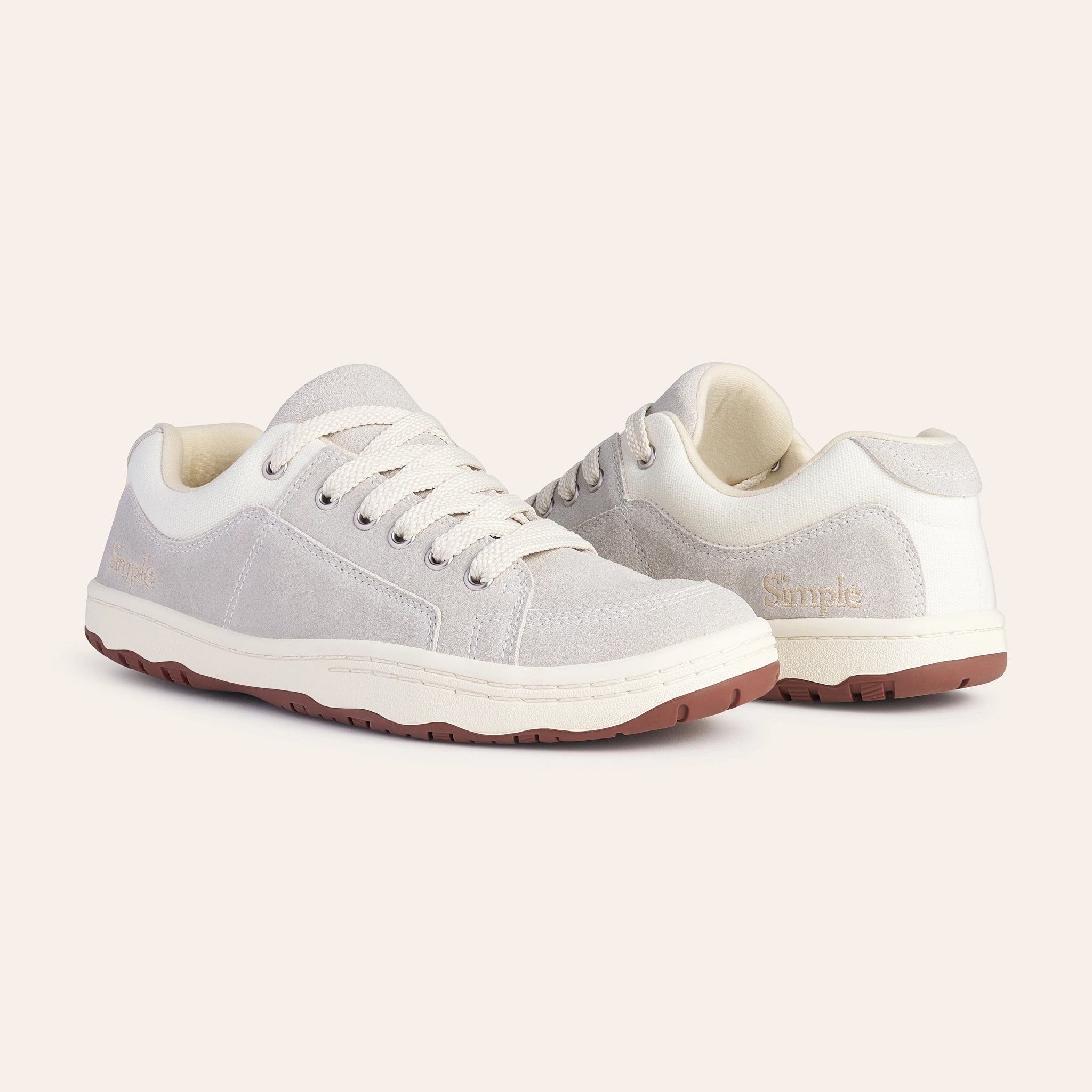 Comfortable beige suede sneakers with white canvas accents and durable rubber sole for casual wear.