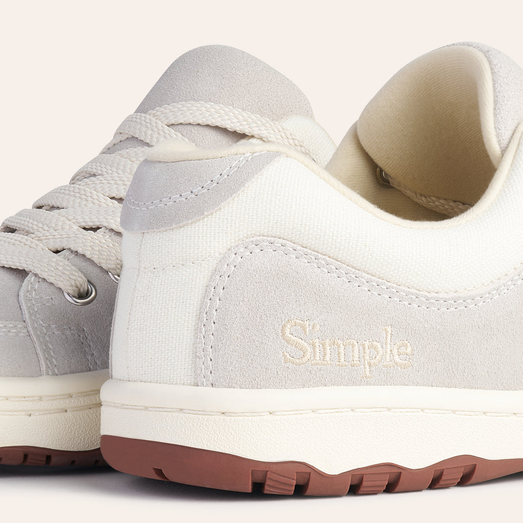 Simple casual sneakers in gray suede and cream canvas with a rubber sole for comfort and style.