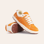 Orange suede sneakers with white laces and rubber outsole, perfect for casual wear.
