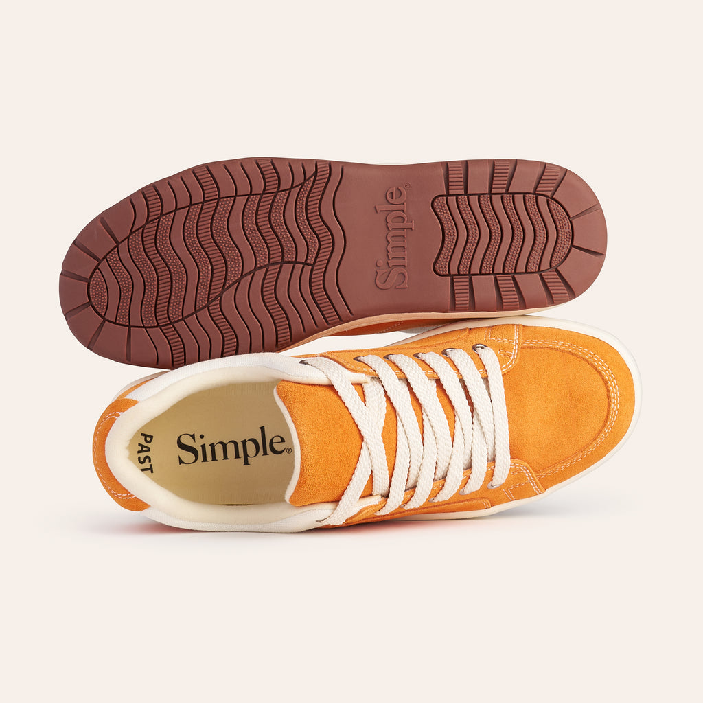 Orange suede casual shoes with white laces and brown rubber sole, perfect for everyday wear.
