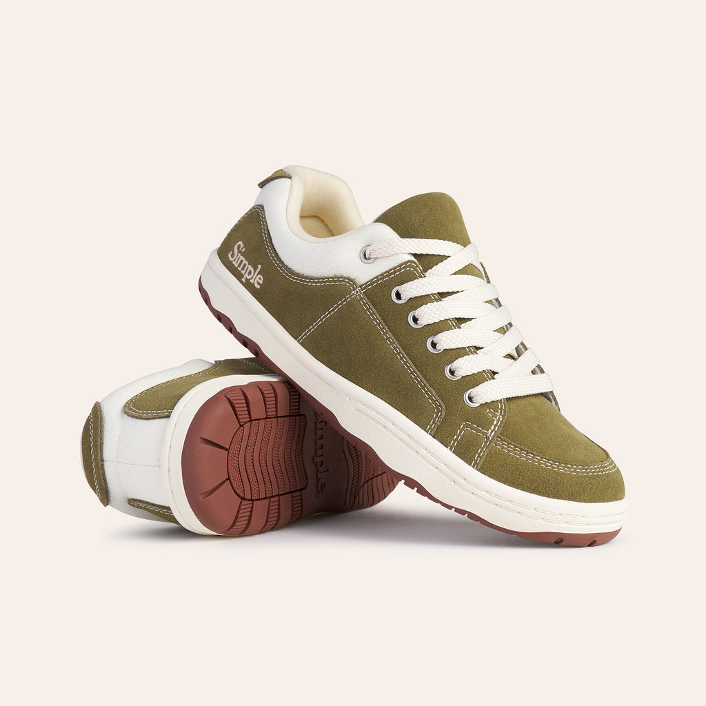 Green suede sneakers with white laces and rubber sole, perfect for casual wear