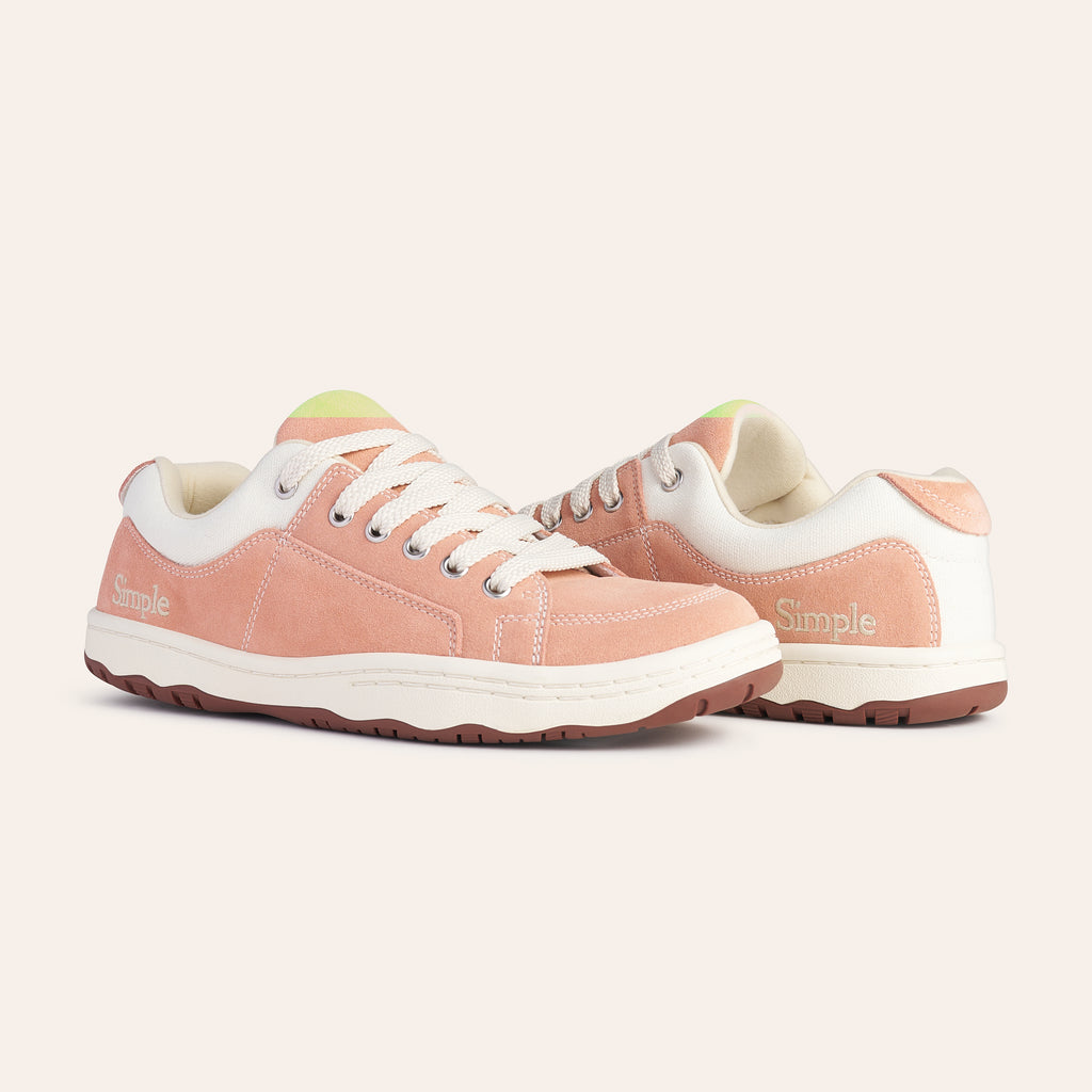 Stylish pink suede sneakers with white accents and laces, perfect for casual wear.